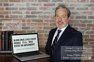 George C. Creal, Jr., P.C., Georgia Drug DUI Lawyer, smiling by a laptop with drug impairment charts