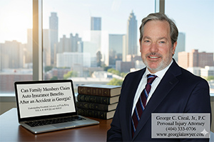 George C. Creal, Jr., P.C. Personal Injury Attorney smiling in an office with a city skyline background